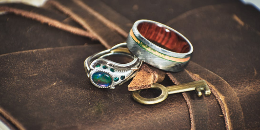 Handcrafted silver rings on a vintage notebook.